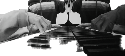 Hands playing piano keys.